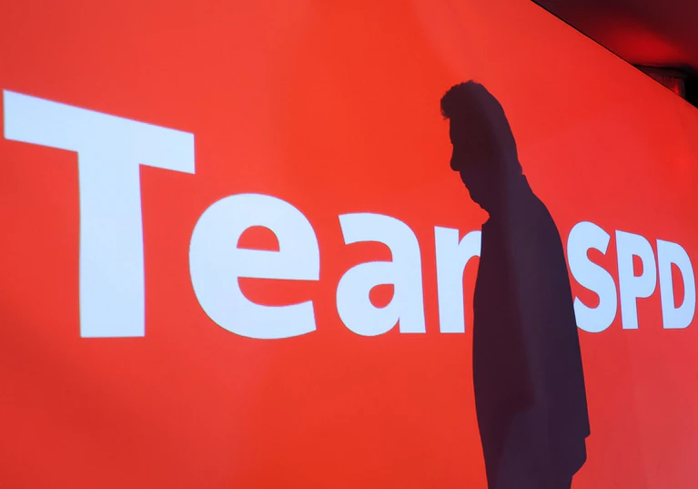 Am Abend der Wahlniederlage fällt Dieter Reiters Schatten auf den Wahlslogan «Team SPD». Aus dem Schriftzug wird «Tear SPD» - Träne. (Archivfoto) — © Karl-Josef Hildenbrand/dpa